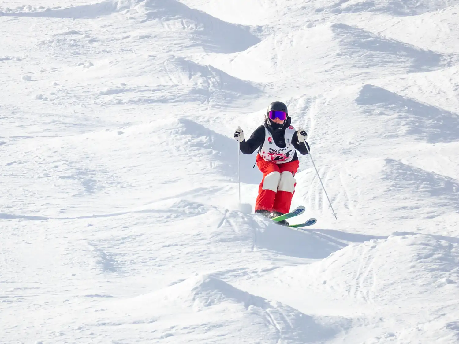 skier switch skiing into a jump at norquay