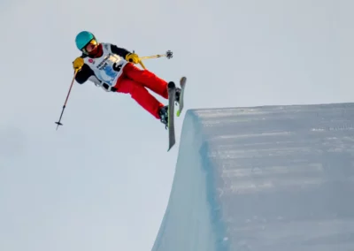 Female freestyle skier dropping into winsport's superpie