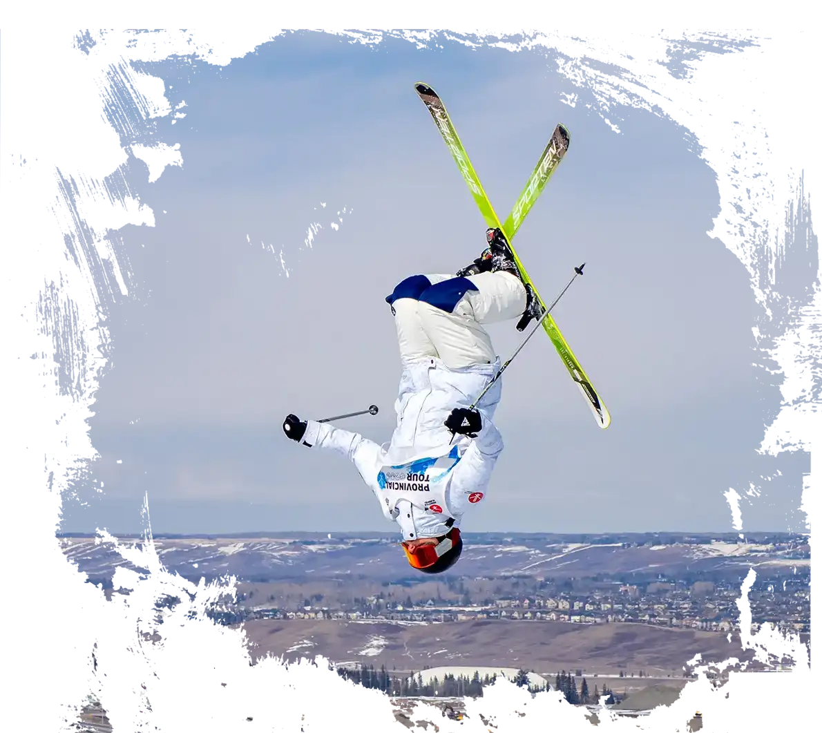 skier doing a spread on a mogul jump at norquay