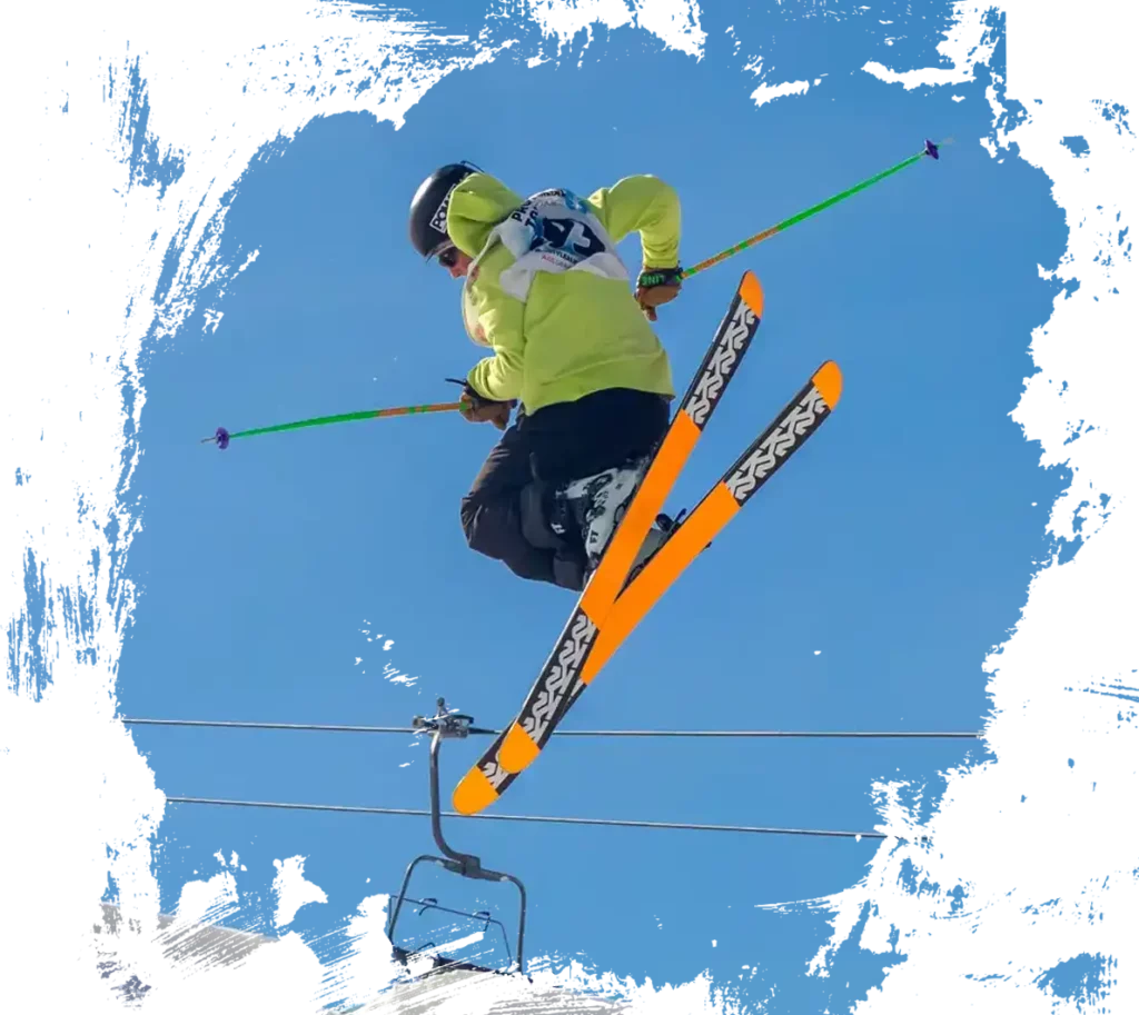 skier doing a spread on a mogul jump at norquay