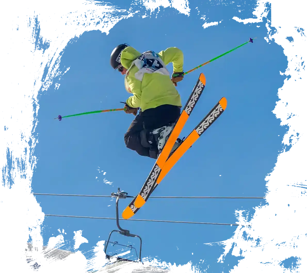 skier doing a spread on a mogul jump at norquay