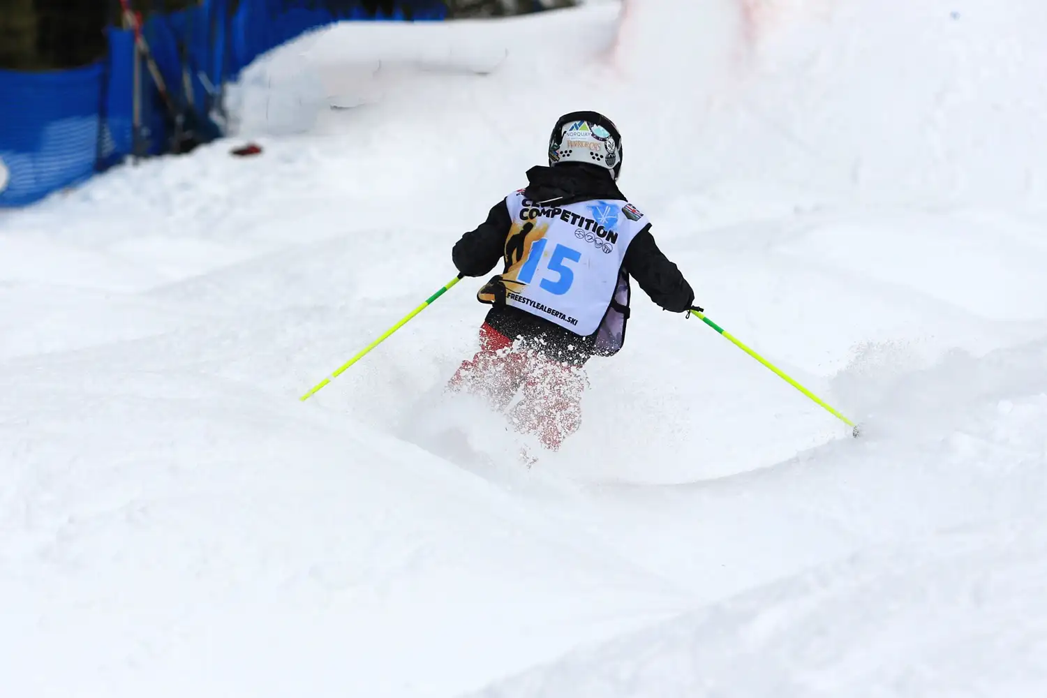 skier switch skiing into a jump at norquay