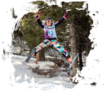 skier doing a spread on a mogul jump at norquay